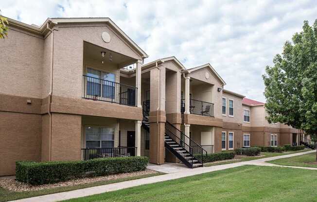 Apartment complex with a green lawn in front.