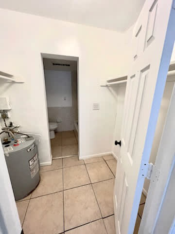 A white door is open to a small bathroom.