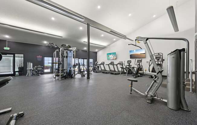 A gym with a variety of exercise equipment.