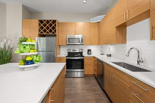 A modern kitchen with wooden cabinets and stainless steel appliances.