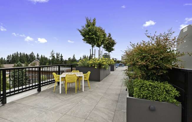 Well Landscaped terrace area with a table and chairs at Arabella Apartment Homes, Shoreline, 98155