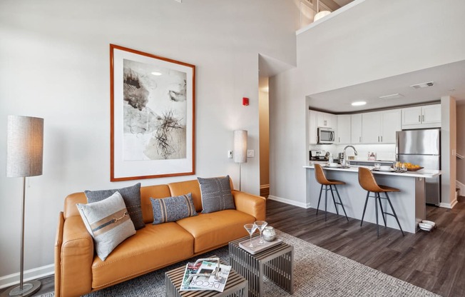 a living room with a couch coffee table and a kitchen in the background at Metro 303, New York