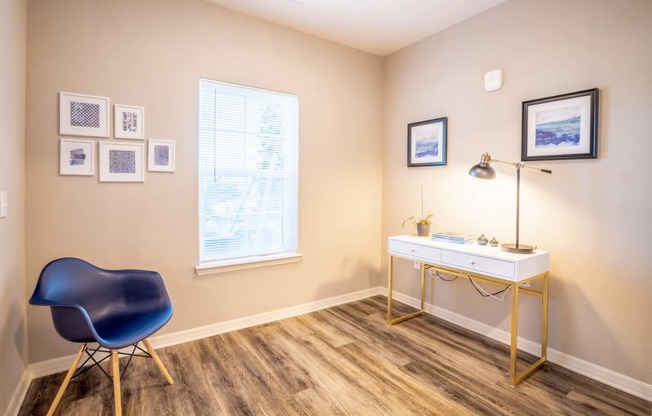 Apartment room with a desk, chair, and window at Trillium apartments