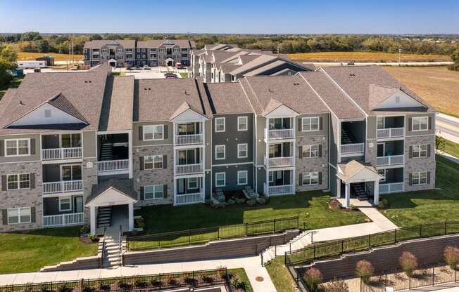 an aerial view of an apartment complex with a field in the background  at Aventura at Hawk Ridge, Lake St Louis, 63367