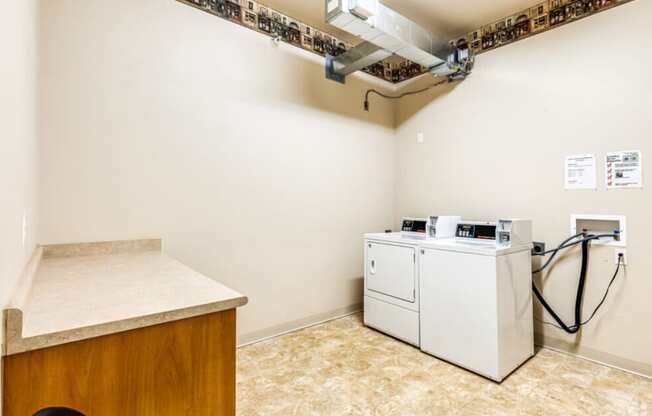 a laundry room with a washer and dryer in it and a counter top