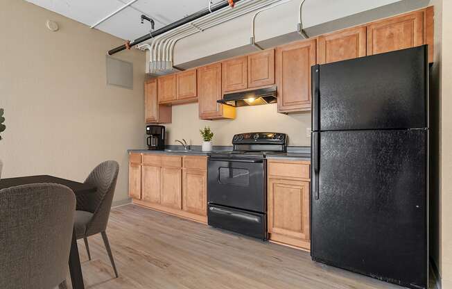 a kitchen with black appliances and wooden cabinets