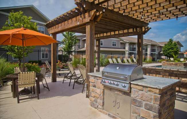 Outdoor Grill With Intimate Seating Area at The Manor Homes of Eagle Glen, Raymore, Missouri