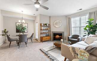 a living room with a fireplace and a table with chairs