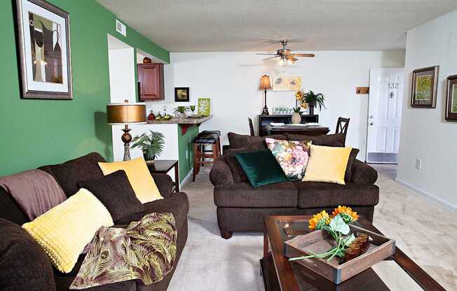 A living room with a brown couch and a coffee table.