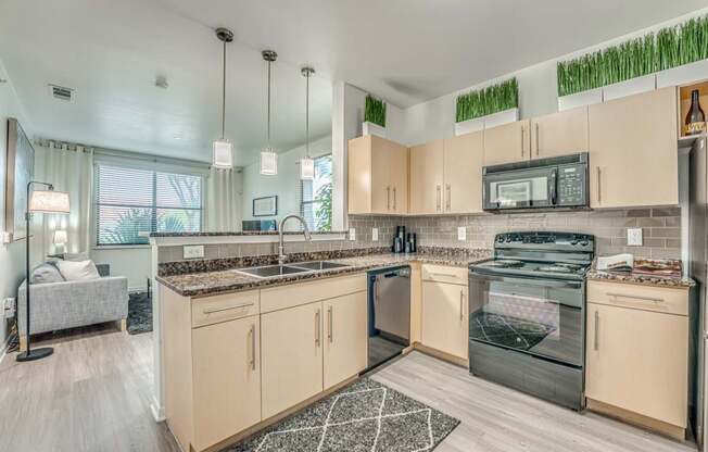 A modern kitchen with wooden cabinets and a black oven.