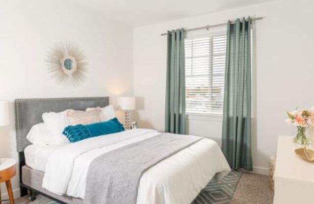Full-size Guest Bedroom with Large Window at Parc on 5th Apartments