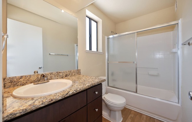 Bathroom with sink toilet and shower with sliding shower doors