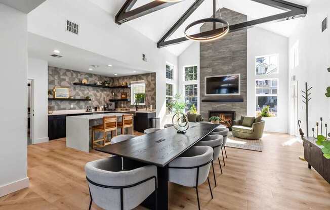 A modern dining room with a large table and chairs.