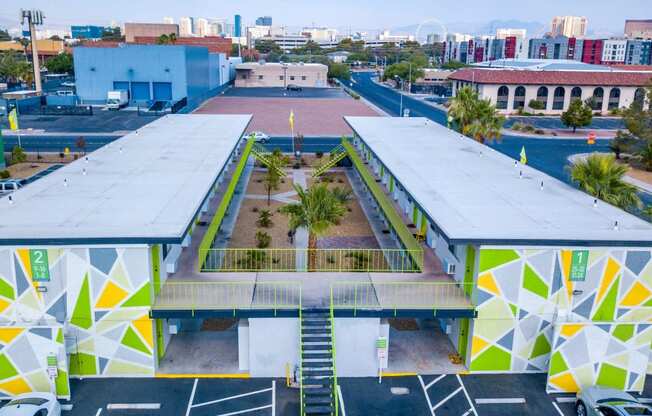 Aerial view of Fusion Las Vegas apartment building with green, yellow, and grey geometric painted walls and lime green railing