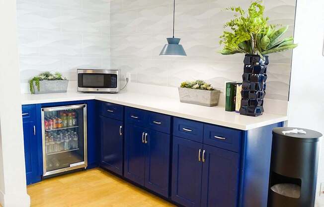 A kitchen with blue cabinets and a white countertop.