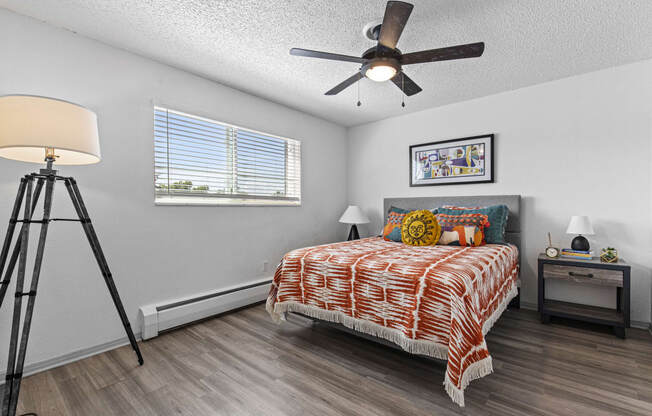 a bedroom with a bed and a ceiling fan