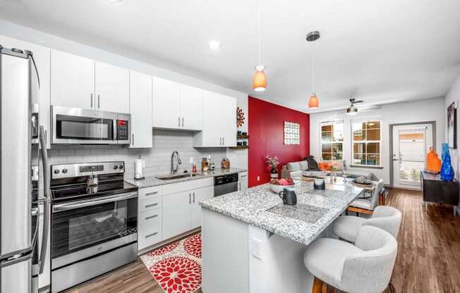 the kitchen and living room of a house with a counter top and