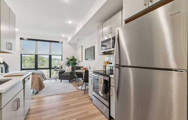 A modern kitchen with a large stainless steel refrigerator.