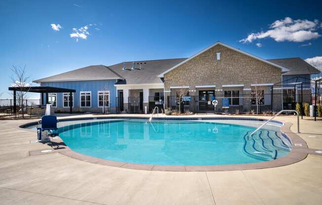 a swimming pool with a house in the background