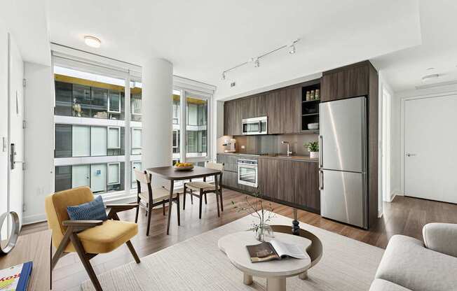 A modern kitchen with a dining table and chairs.