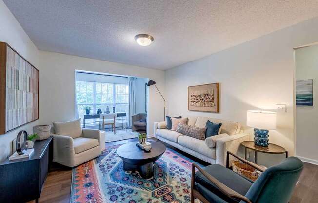 A living room with a rug and a couch.