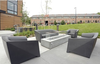 Outdoor kitchen area with barbecue and dining table.