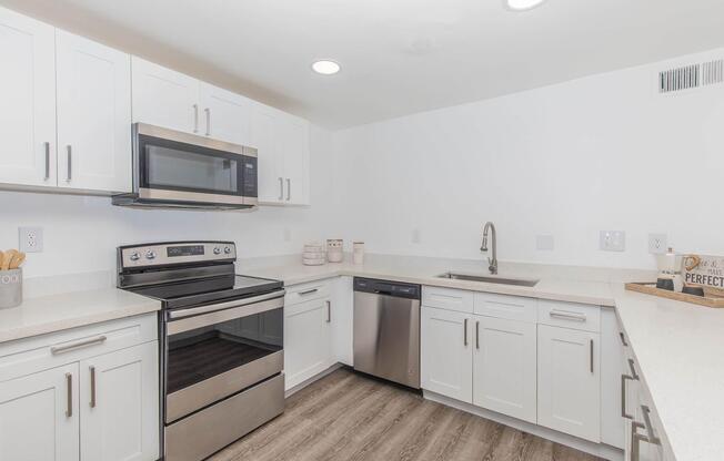a stove top oven sitting inside of a kitchen