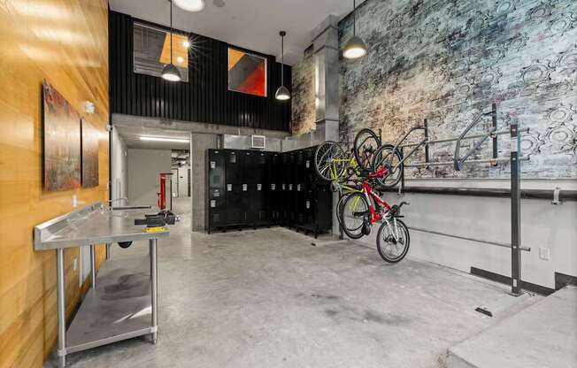 A room with a bicycle hanging on the wall.