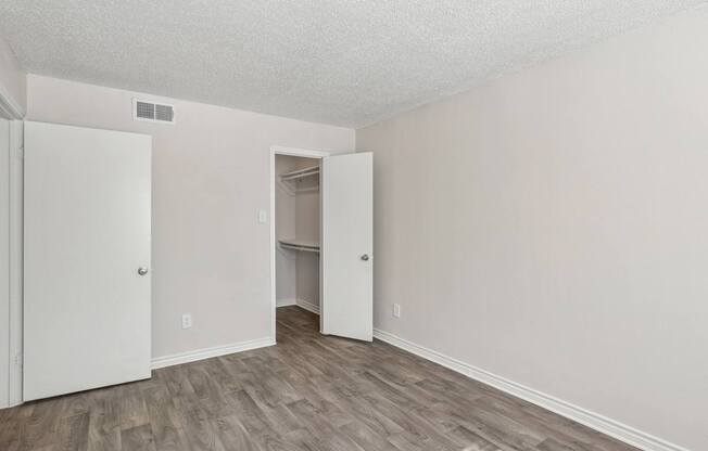 A room with a white door and a white closet.