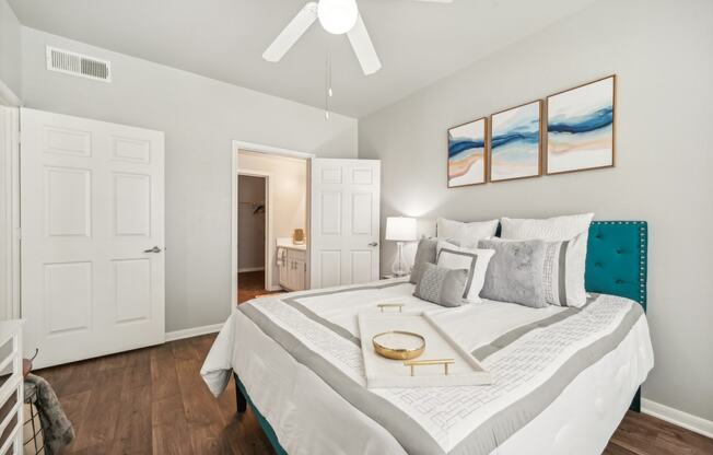 a bedroom with a large bed and a ceiling fan