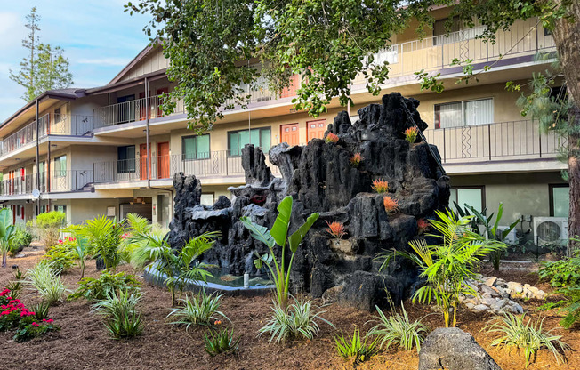 a building with a rock sculpture in the front of it
