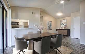 A dining room with a table and chairs.
