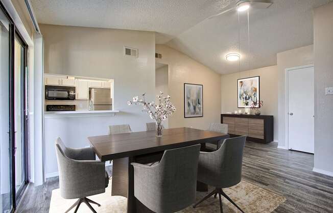 A dining room with a table and chairs.