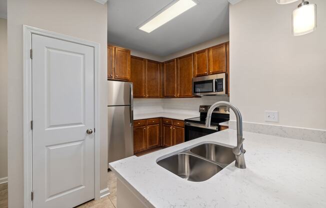 a kitchen with stainless steel appliances and white counter tops