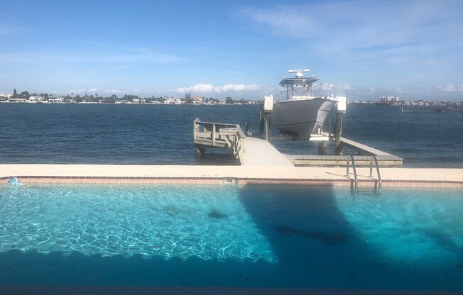 Beautiful unobstructed view of the intracoastal waterways of Boca Ciega with pool, dock and boat slip.