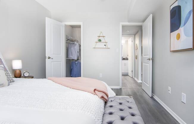 a bedroom with a bed and a closet      and a hallway