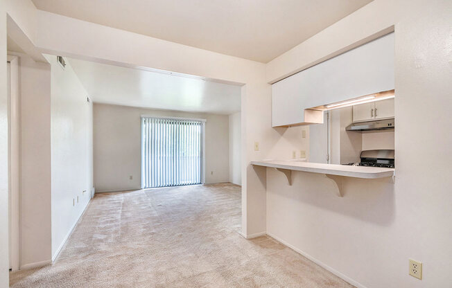 Dining area leading to living room at West Wind Apartments in Fort Wayne, IN