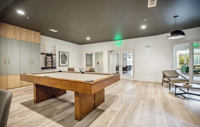 A room with a pool table and a chair.