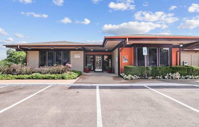 A building with a parking lot in front of it.