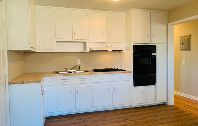 Beautiful hardwood flooring! 2 bed, 1 full bath plus office/possible 3rd bedroom, large kitchen, cooktop, newly renovated, parking for 2, deck, must see!