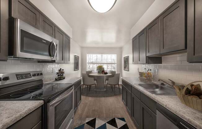 Kitchen with mosaic tiles and cabinets at The Apartments at Owings Run, Maryland, 21117