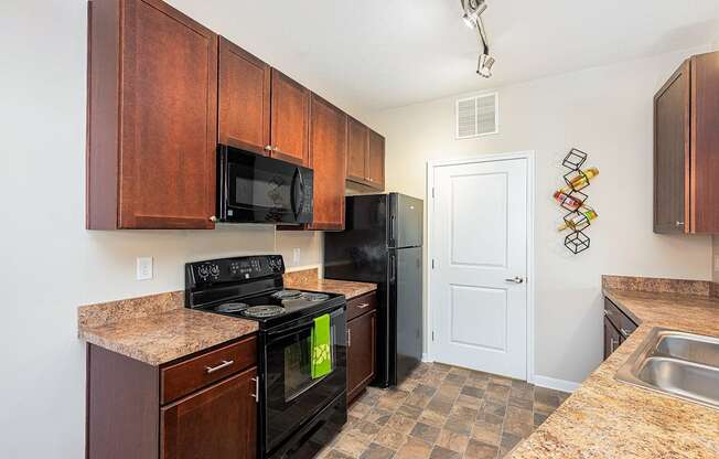 a kitchen with black appliances and granite counter tops