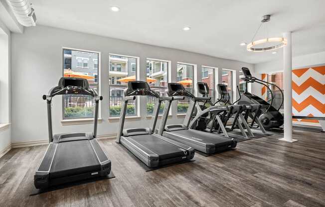 A gym with treadmills and elliptical machines.