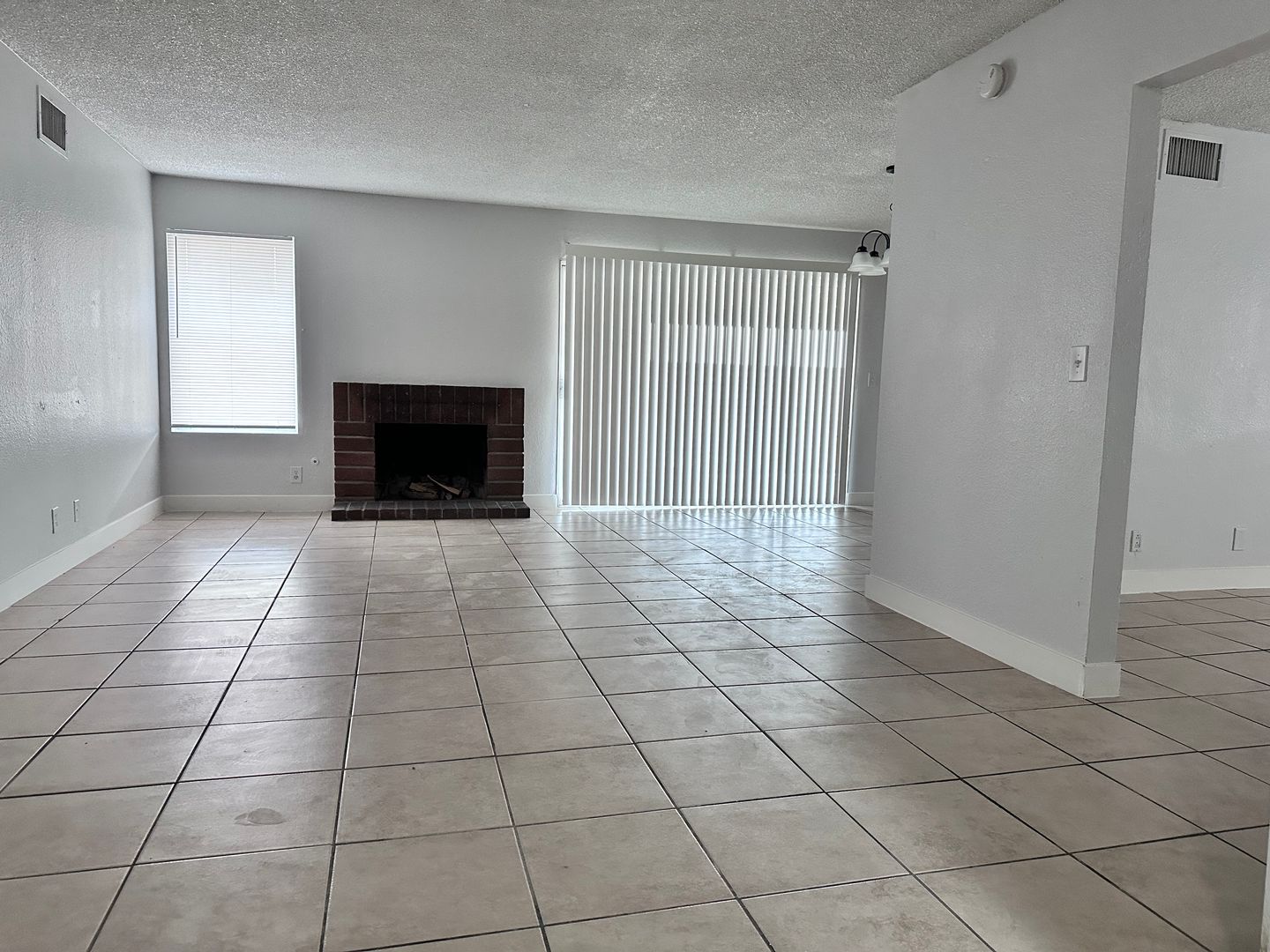 FRESH PAINT INSIDE, 4 BEDROOM HOME HAS A VERY SPACIOUS OPEN LAYOUT THAT FEATURES A FIREPLACE AND SEPARATE HIDDEN KITCHEN SPACE