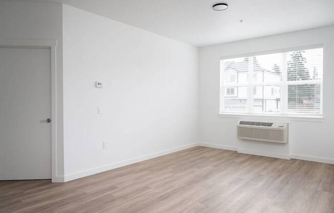 A room with a window and a door.