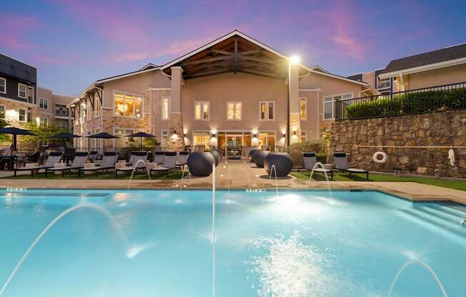 A large house with a pool in front of it.