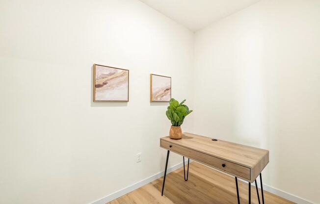 a room with a wooden table and two paintings on the wall at The Standard on 32nd, West Fargo, ND, 58078