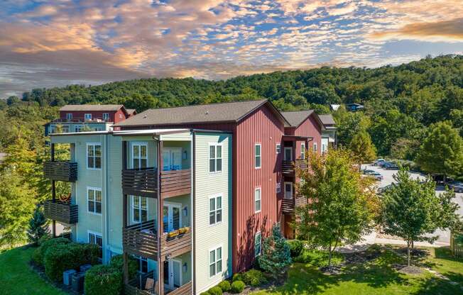 an aerial view of a building with a mountain in the background at River Mill Lofts & Skyloft, North Carolina