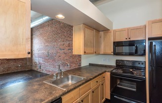 a kitchen with a counter top and a sink at Mayton Transfer Lofts, Petersburg