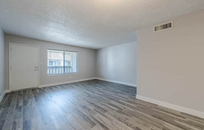 A room with a window and a door.